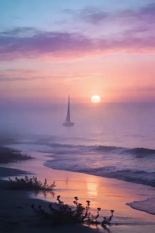 海边雾中夕阳下的帆船